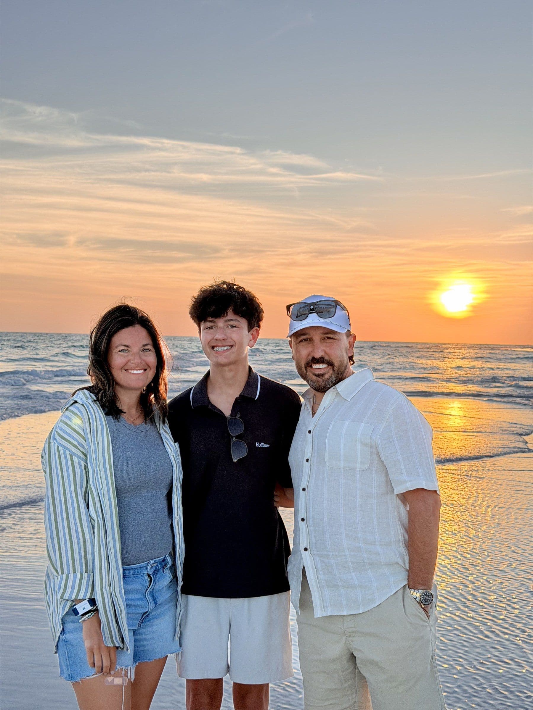 Joshua Brown with family on the beach at sunset